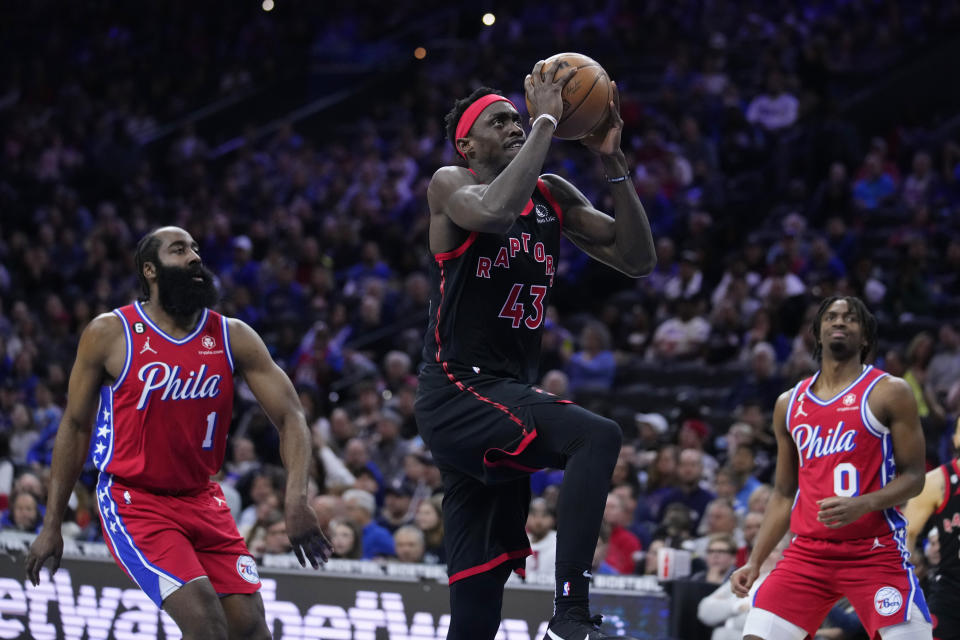 Toronto Raptors' Pascal Siakam (43) goes up for a shot in front of Philadelphia 76ers' James Harden (1) and Tyrese Maxey during the first half of an NBA basketball game Friday, March 31, 2023, in Philadelphia. (AP Photo/Matt Rourke)