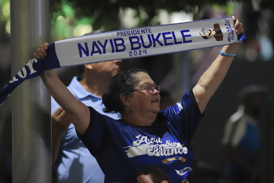 A supporter of Salvador President Nayib Bukele, who is seeking re-election, celebrates results of a general election at the Gerardo Barrios square in downtown San Salvador, El Salvador, Sunday, Feb. 4, 2024. (AP Photo/Salvador Melendez)