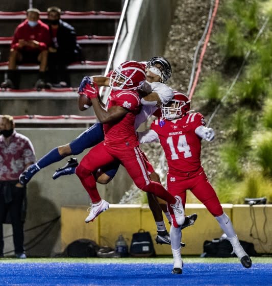 Mater Dei's Shu'yab Brinkley intercepts a pass in the end zone intended for St John Bosco's James Chedon on April 17, 2021.