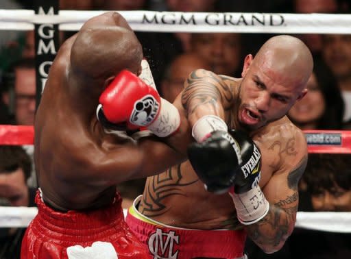 Miguel Cotto (R) grazes Floyd Mayweather during their WBA super welterweight title fight at the MGM Grand in Las Vegas, on Saturday, May 5. Mayweather won the title in a 12 round unanimous decision