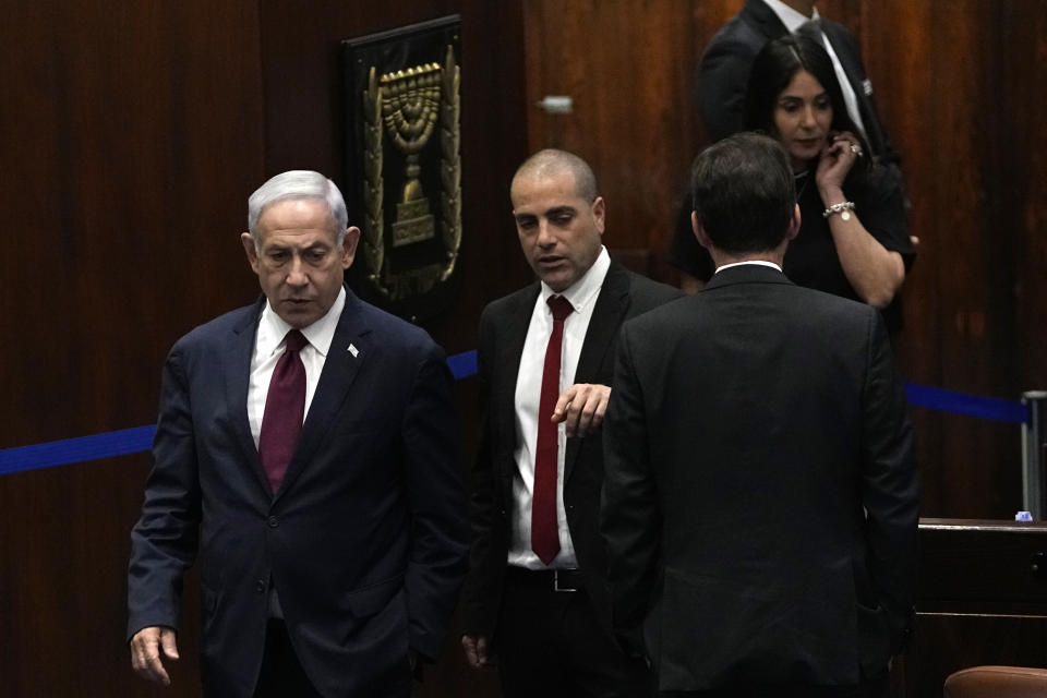 Israeli Prime Minister Benjamin Netanyahu, left, arrives for a vote on picking two lawmakers to serve on a judge selection panel, in the Knesset, Israel's parliament, Jerusalem, Wednesday, June 14, 2023. (AP Photo/Ohad Zwigenberg)