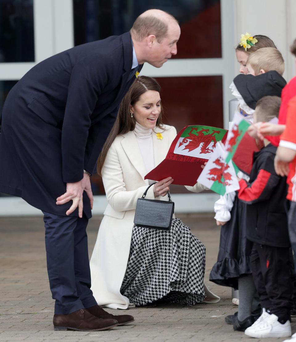 Prince William, Prince of Wales and Catherine, Princess of Wales speak with young well-wishers as they depart Aberavon Leisure & Fitness Centre
