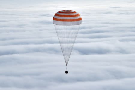 A Soyuz capsule carrying International Space Station (ISS) crew members U.S. astronaut Scott Kelly, Russian cosmonauts Sergei Volkov and Mikhail Korniyenko descends beneath a parachute near the town of Dzhezkazgan (Zhezkazgan), Kazakhstan, March 2, 2016. REUTERS/Kirill Kudryavtsev/Pool