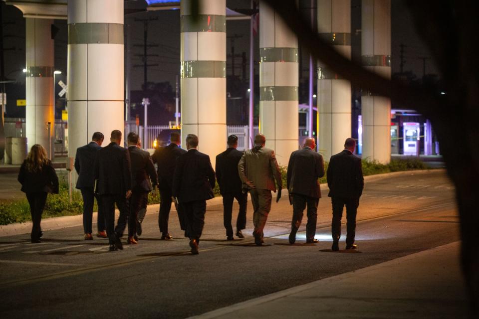 Detectives comb the scene where two L.A. County Sheriff's deputies were shot.