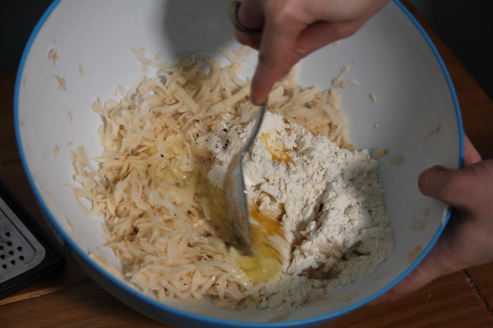 Latke ingredients mixed in a bowl.