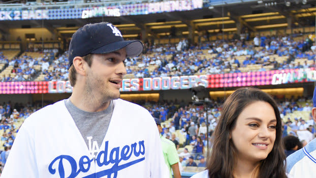 Pregnant Mila Kunis and hubby Ashton Kutcher put on PDA in matching outfits  at LA Dodgers crucial playoff game