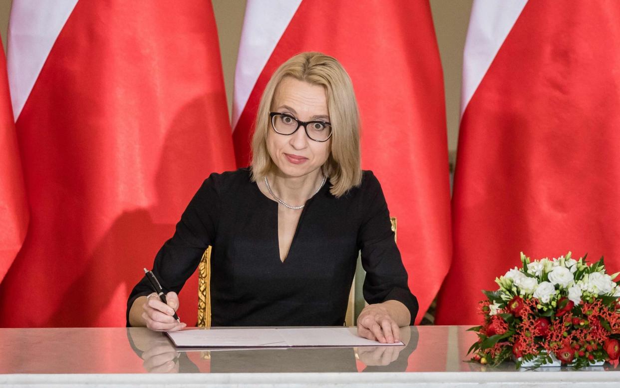 Newly-appointed Finance Minister, Teresa Czerwinska, signs during an investiture ceremony with the Polish president  - AFP