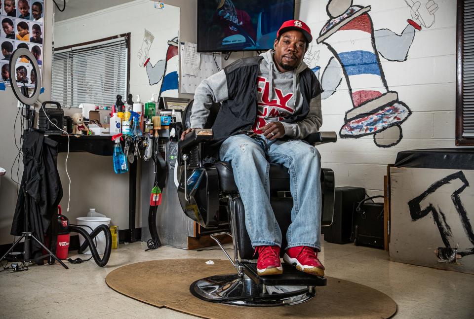 Tommy Dotson waits for his first customer of the day inside his barbershop, T.E.DÕZ Barbershop, on Indianapolis' south side Friday, Oct. 8, 2021. Dotson used $15,000 of his savings, money left to him by his mother, to repair the old building and opened in February 2020, One month later COVID-19 forced him to shut down. This was one of a series of obstacles Dotson has faced along the way to opening the shop, but despite the obstacles, he remains optimistic.