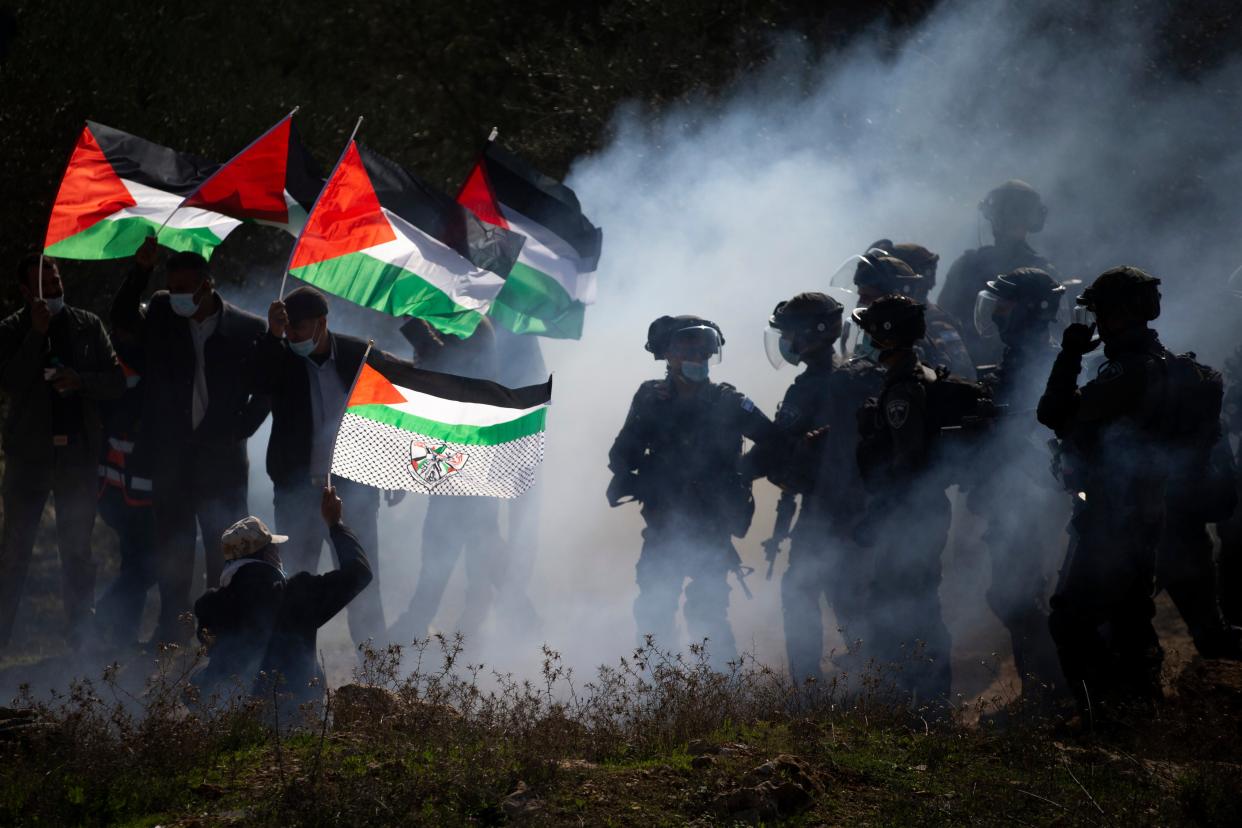 <p>Israeli border police officers and Palestinians clash during a protest against the expansion of Israeli Jewish settlements near the West Bank town of Salfit in December</p> (AP)