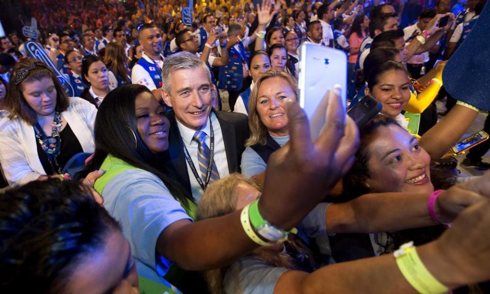 Greg Foran (center), chief executive officer of Walmart, takes photos with associates before the annual Walmart shareholders meeting in 2016. The company has announced it has achieved its goal to buy $20bn worth of goods and services from women-owned businesses in the US over five years.