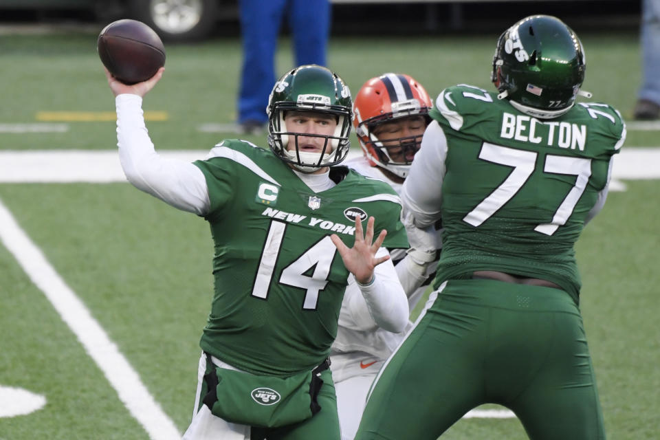 New York Jets quarterback Sam Darnold (14) throws a pass during the second half of an NFL football game as offensive tackle Mekhi Becton (77) blocks Cleveland Browns' Myles Garrett, Sunday, Dec. 27, 2020, in East Rutherford, N.J. (AP Photo/Bill Kostroun)