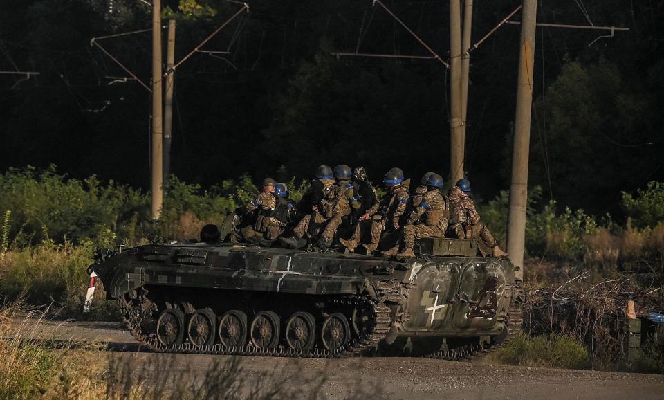 Ukrainian army fighters sit on the top of an armed vehicle in Kharkiv on Sept. 9, 2022, amid Russian invasion of Ukraine.