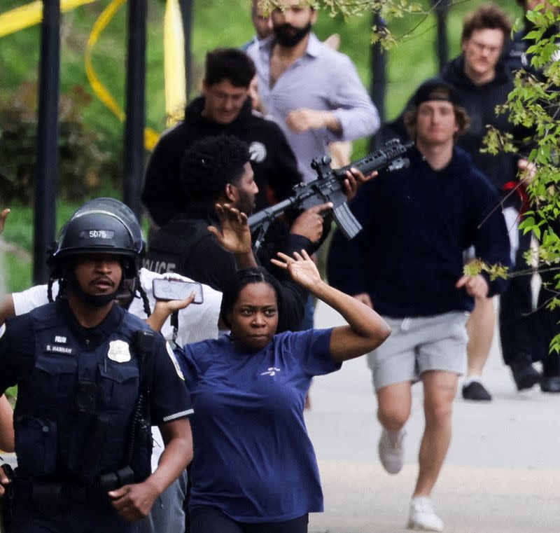 FILE PHOTO: Law enforcement officers evacuate civilians to safety near scene of a reported shooting and active shooter near Edmund Burke School in Washington