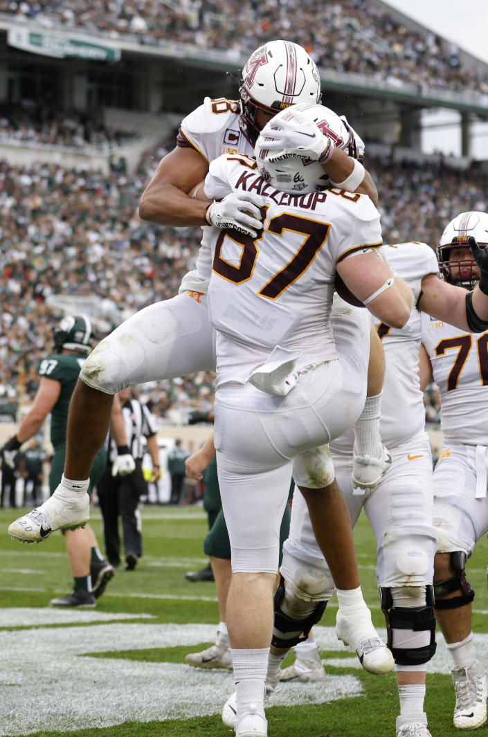 Minnesota's Nick Kallerup (87) celebrates his touchdown against Michigan State with Brevyn Spann-Ford, rear, during the second half of an NCAA college football game, Saturday, Sept. 24, 2022, in East Lansing, Mich. Minnesota won 34-7. (AP Photo/Al Goldis)