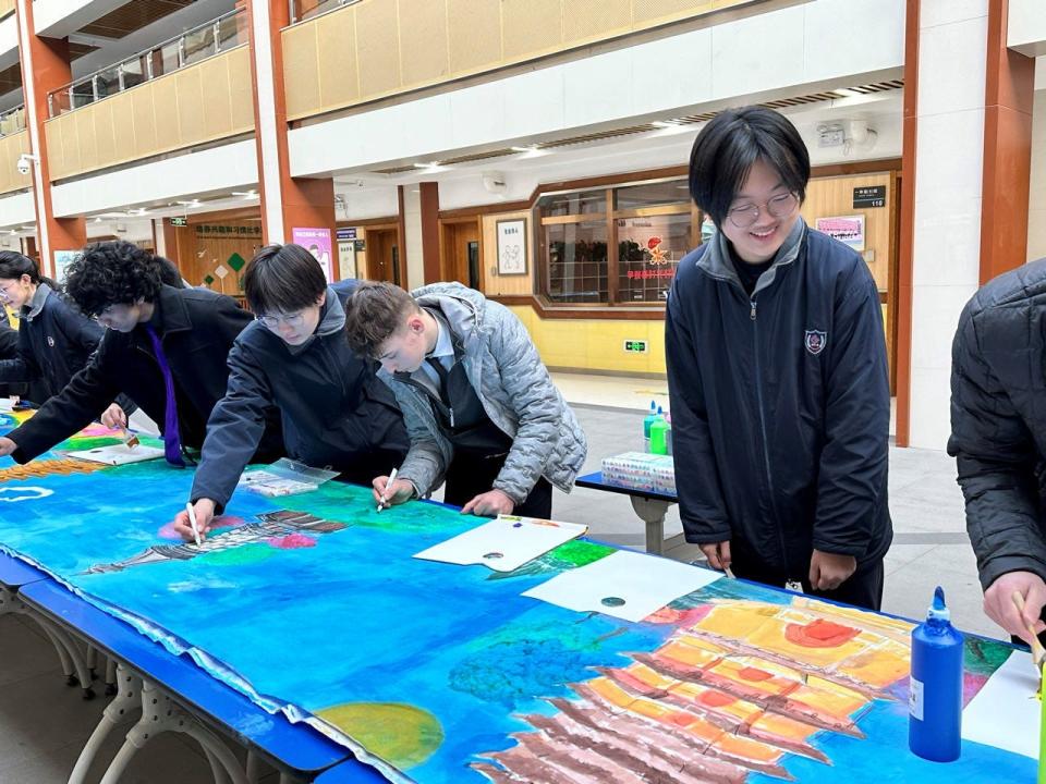 Muscatine students create a mural with their Chinese peers commemorating their trip to China.