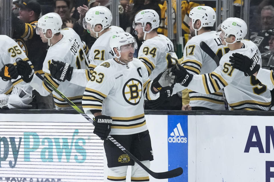 Boston Bruins left wing Brad Marchand (63) celebrates with teammates after scoring during the second period of an NHL hockey game against the Los Angeles Kings Saturday, Oct. 21, 2023, in Los Angeles. (AP Photo/Ashley Landis)