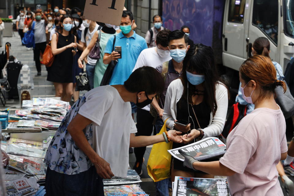 People queue to buy copies of the final edition of Apple Daily, published by Next Digital, in the Central financial district, in Hong Kong, China June 24, 2021. REUTERS/Tyrone Siu