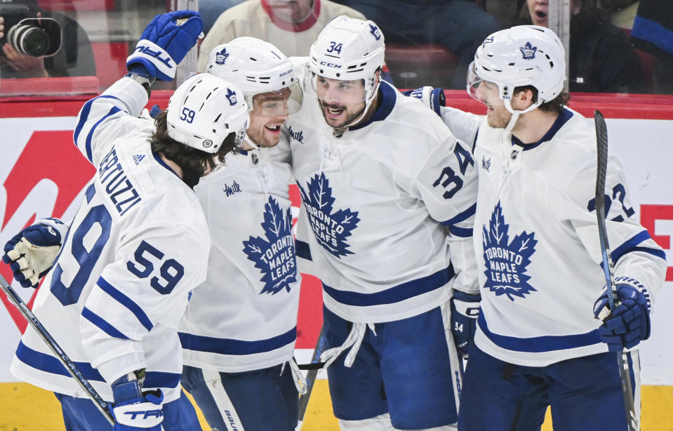 Toronto Maple Leafs' Auston Matthews (34) celebrates with teammates after scoring against the Montreal Canadiens during the second period of an NHL hockey game in Montreal, Saturday, April 6, 2024. (Graham Hughes/The Canadian Press via AP)