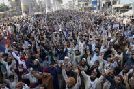 Supporters of Tehreek-e-Labiak Pakistan, a banned Islamist party, chant slogans during a protest on the arrest of their party leader Saad Rizvi, who was demanding the government to expel French ambassador, in Lahore, Pakistan, Monday, April 19, 2021. The outlawed Pakistani Islamist political group freed 11 policemen almost a day after taking them hostage in the eastern city of Lahore amid violent clashes with security forces, the country's interior minister said Monday. (AP Photo/K.M. Chaudary)