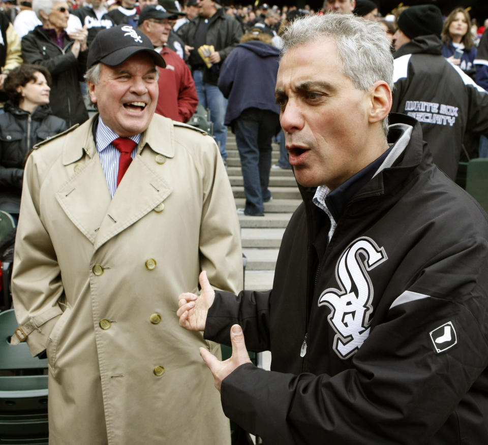 FILE - In this April 7, 2011 file photo, Chicago Mayor Richard M. Daley, left, and Mayor-elect Rahm Emanuel share a moment at a Chicago White Sox game at U.S. Cellular Field in Chicago. Emanuel, the hard-charging mayor is intent on fixing what ails the nation’s third-largest city. Emanuel once nicknamed “Rahmbo” for his fierce political maneuvering, last week announced an agreement with several unions to help bail out the nation’s worst-funded city pension systems, a festering problem he inherited from Daley. Emanuel said the deal, which would slice Chicago’s nearly $20 billion shortfall in half by cutting benefits and raising property taxes, would keep the funds from insolvency and avoid massive cuts in services and a record tax hike. (AP Photo/Charles Rex Arbogast, File)