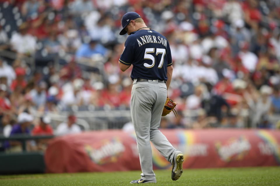 Milwaukee Brewers starting pitcher Chase Anderson walks toward the dugout after he was pulled during the third inning of a baseball game against the Washington Nationals, Sunday, Aug. 18, 2019, in Washington. (AP Photo/Nick Wass)