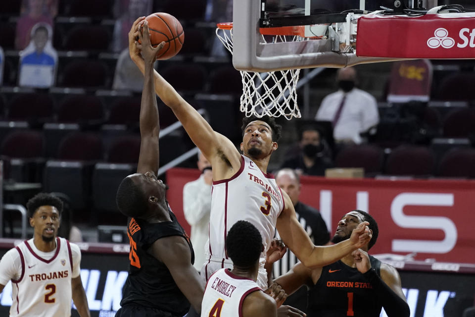 Southern California forward Isaiah Mobley (3) and Oregon State forward Dearon Tucker, second from left, reach for a rebound during the first half of an NCAA college basketball game Thursday, Jan. 28, 2021, in Los Angeles. (AP Photo/Ashley Landis)