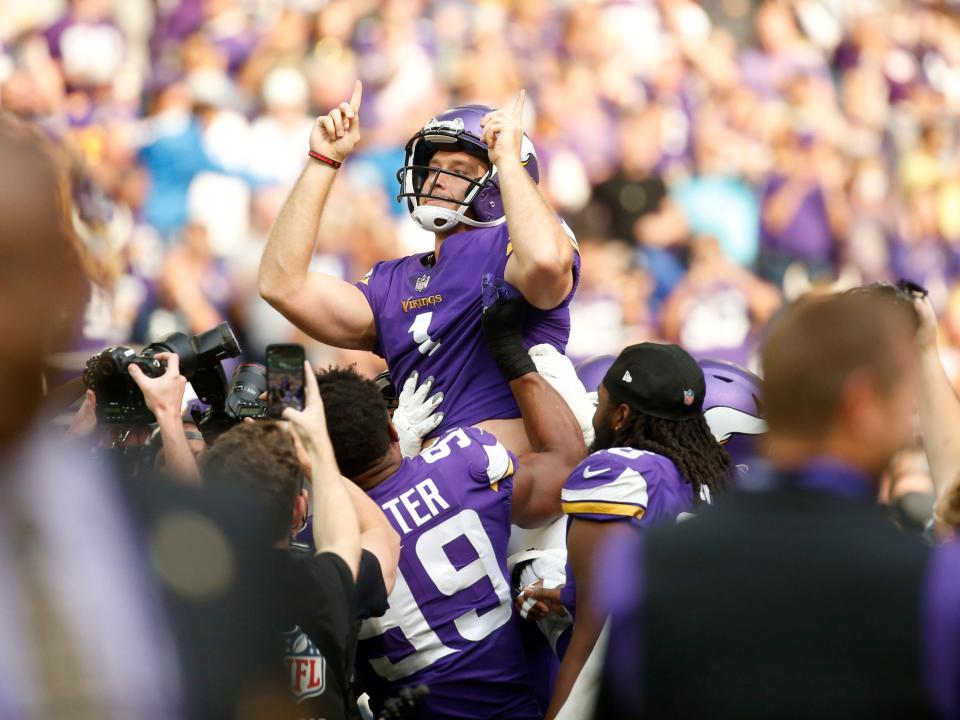 Greg Joseph celebrates with teammates after a game-winning field goal against the Detroit Lions.