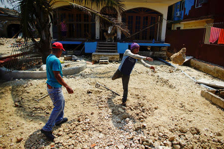 Men work at a damaged house after Hurricane Irma passed, in Havana, Cuba, September 16, 2017. REUTERS/Alexandre Meneghini