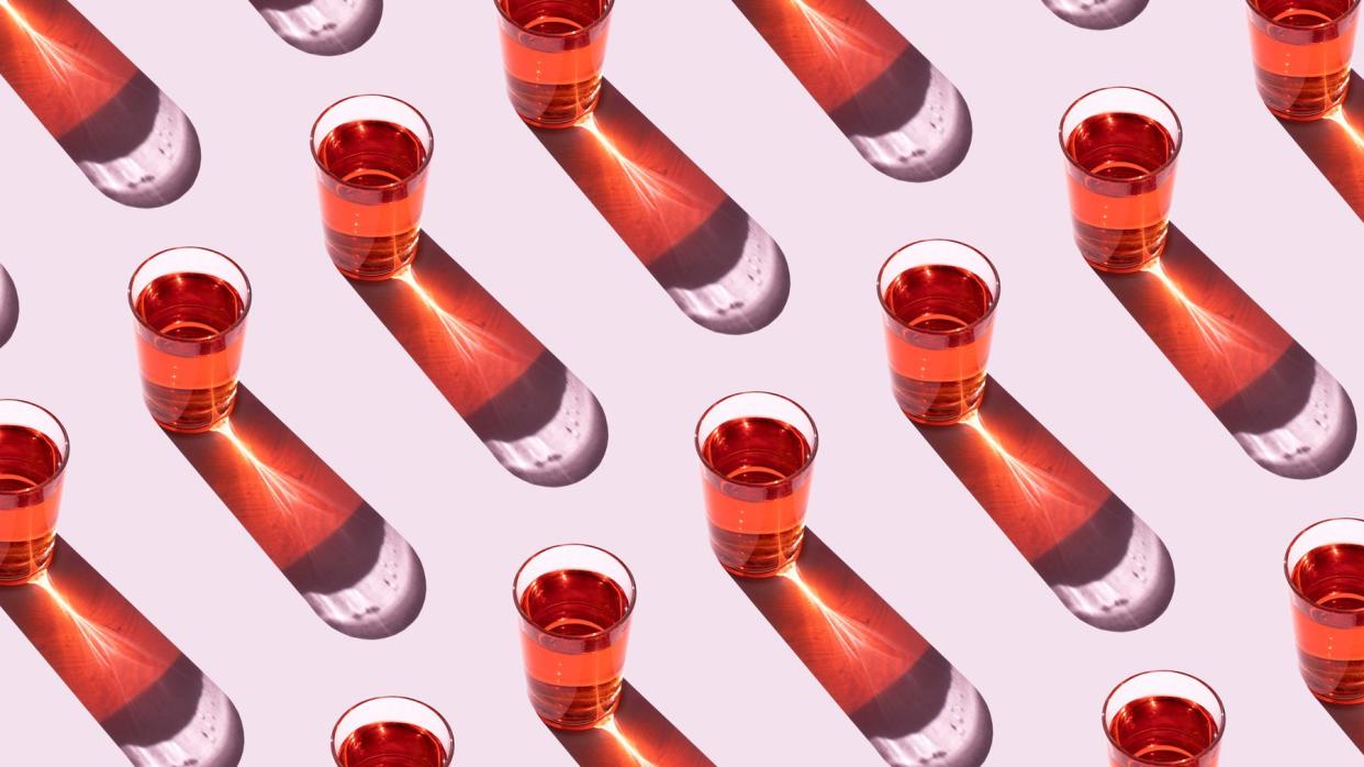 How to Drink Mindfully With Meditation: red glasses lined up in rows on a pink background