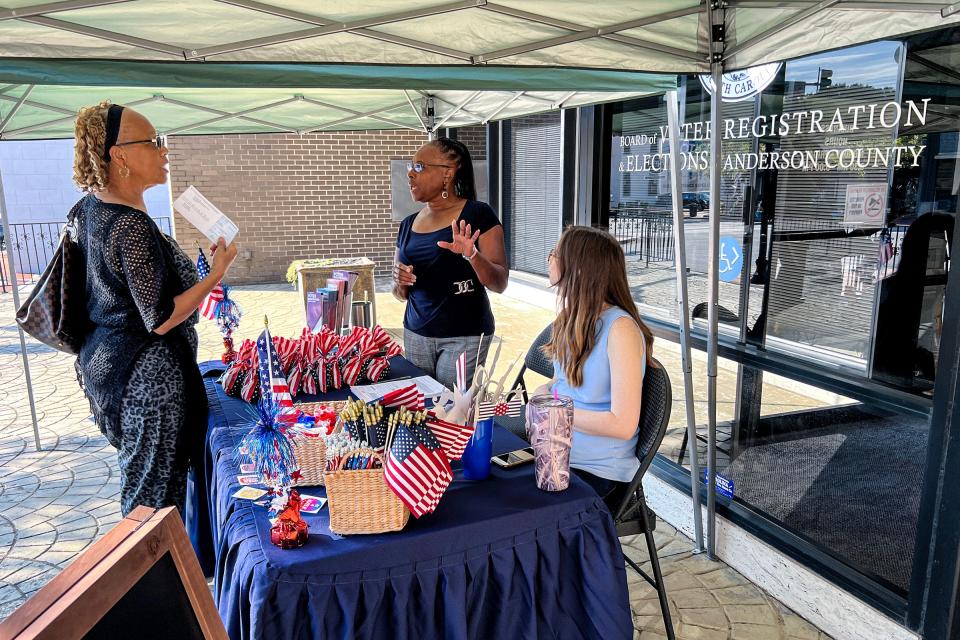 Jannie Bolden, left, of Anderson arrives to talk with Carolyn Williams, middle, Election Clerk and Carissa Smith, right, voter services supervisor, about registering to vote in the booth outside the Anderson County Board of Voter Registration and Elections office in downtown Anderson, SC Tuesday, September 20, 2022.