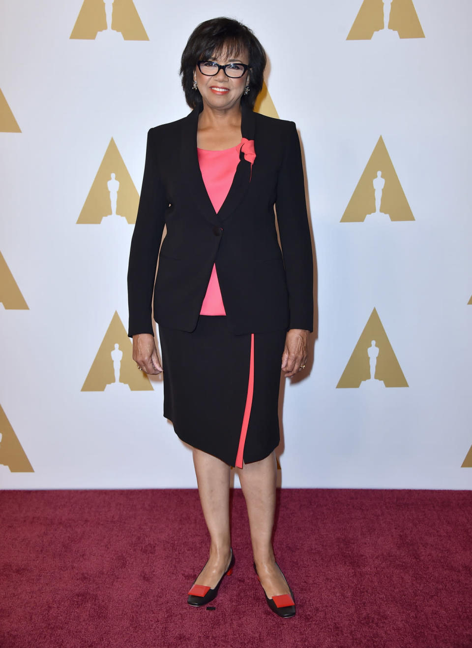 Cheryl Boone Isaacs, president of the Academy of Motion Picture Arts and Sciences, in a hot pink and black skirt suit at the 88th Annual Academy Awards nominee luncheon on February 8, 2016 in Beverly Hills, California.