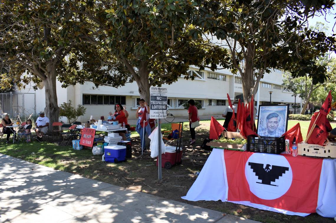 Supporters of the United Farm Workers camped outside state government offices in Fresno to pressure Gov. Gavin Newsom to sign a bill that could grant farmworkers the flexibility to vote by mail in union elections on Aug. 30, 2022. Five supporters spent the night from Monday to Tuesday at this location, dozing a bit while chatting and keeping warm with blankets in their chairs.