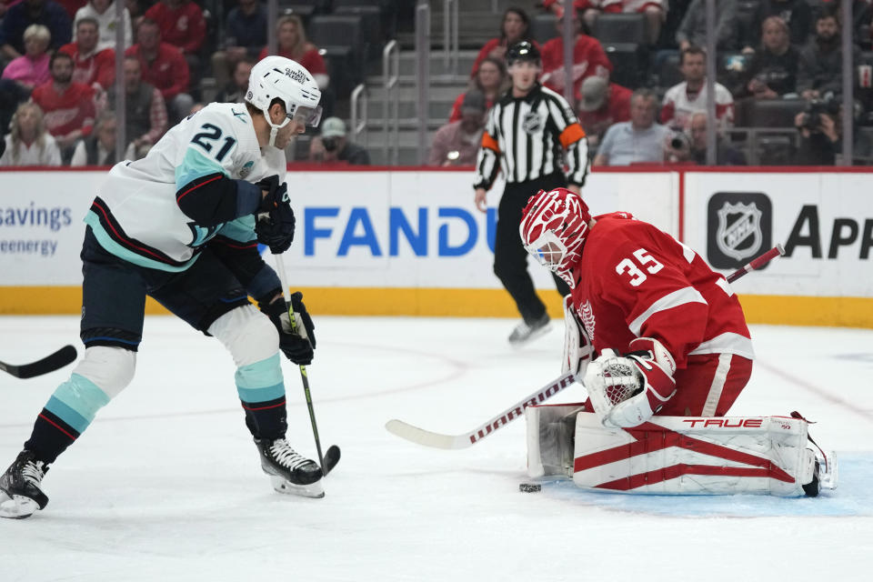 Detroit Red Wings goaltender Ville Husso (35) stops a Seattle Kraken center Alex Wennberg (21) shot in the first period of an NHL hockey game Tuesday, Oct. 24, 2023, in Detroit. (AP Photo/Paul Sancya)