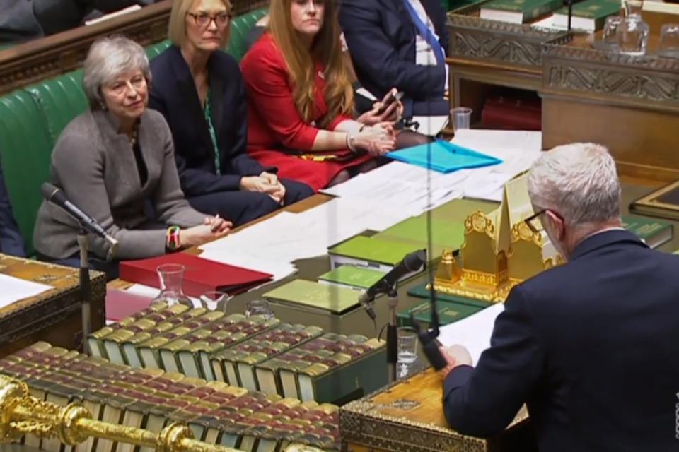 Theresa May watches as Jeremy Corbyn announces he will table a motion of no confidence in her. She then got up and walked out of the chamber (AFP/Getty Images)