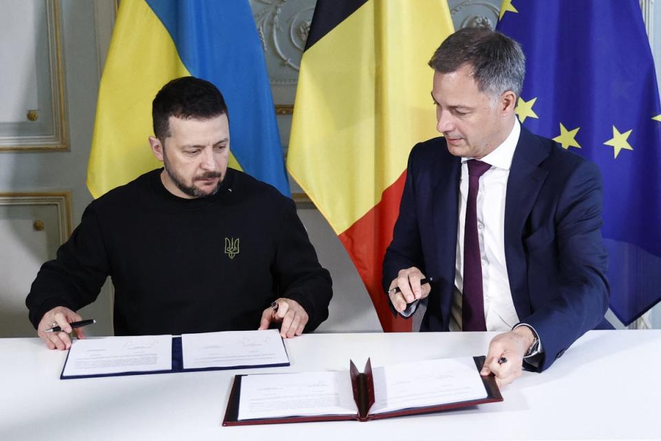 Ukrainian President Volodymyr Zelensky and Belgian Prime Minister Alexander De Croo sign a bilateral security agreement in Brussels (POOL/AFP via Getty Images)
