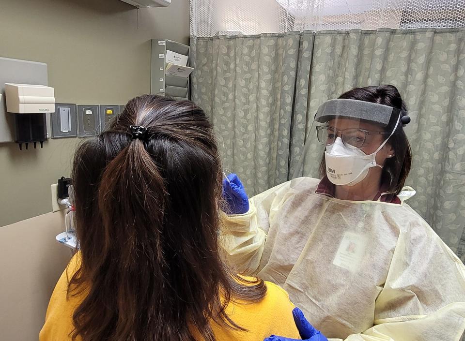 Amy Richardson, NP-C, performs a nasal swab at Maury Regional Health facility in Columbia, Tenn., on Wednesday, Jan 5, 2021.