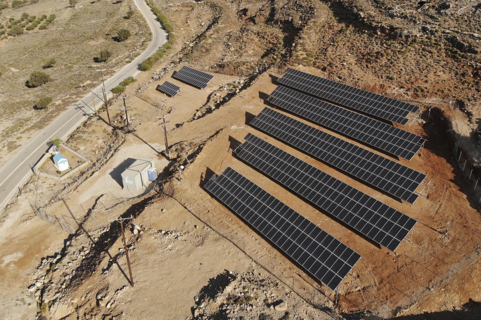 In this Thursday , Aug. 9, 2018, photo, a solar park on the Aegean island of Tilos, Greece. Tilos with its winter population of 400 and summer population of some 3000, will become the first island in the Mediterranean to run exclusively on wind and solar power, when the blades of the 800 kilowatt wind turbine start turning. (AP Photo/ Iliana Mier)