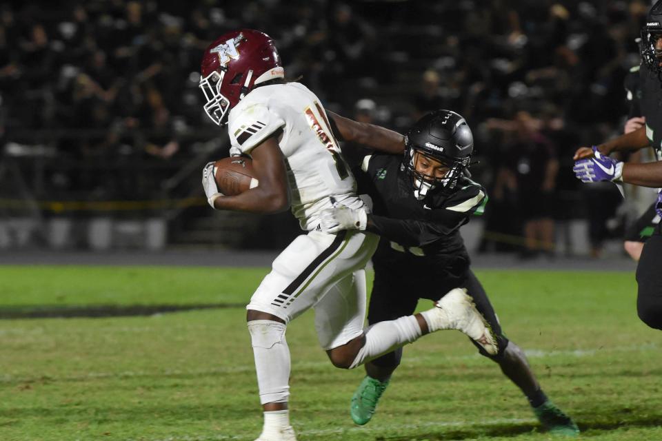 Choctawhatchee High School's Justin Whidbee gets a grip on Niceville High School's Demontre Allen as he runs the ball during a game on Friday, Sept. 23, 2022 at Etheredge Stadium.