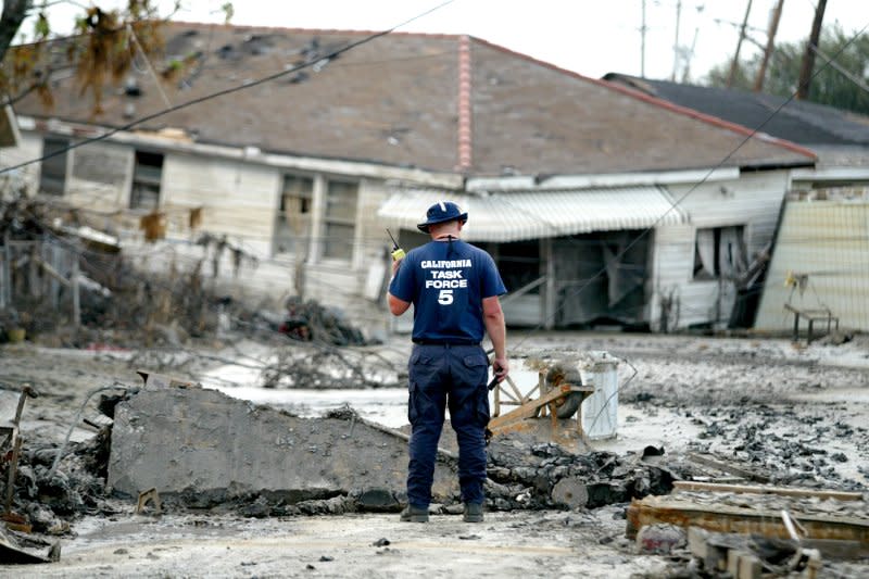 A California rescue worker surveys a home left in the middle of a street in the 9th Ward of New Orleans in the wake of Hurricane Katrina in 2005. File Photo by Ken James/UPI