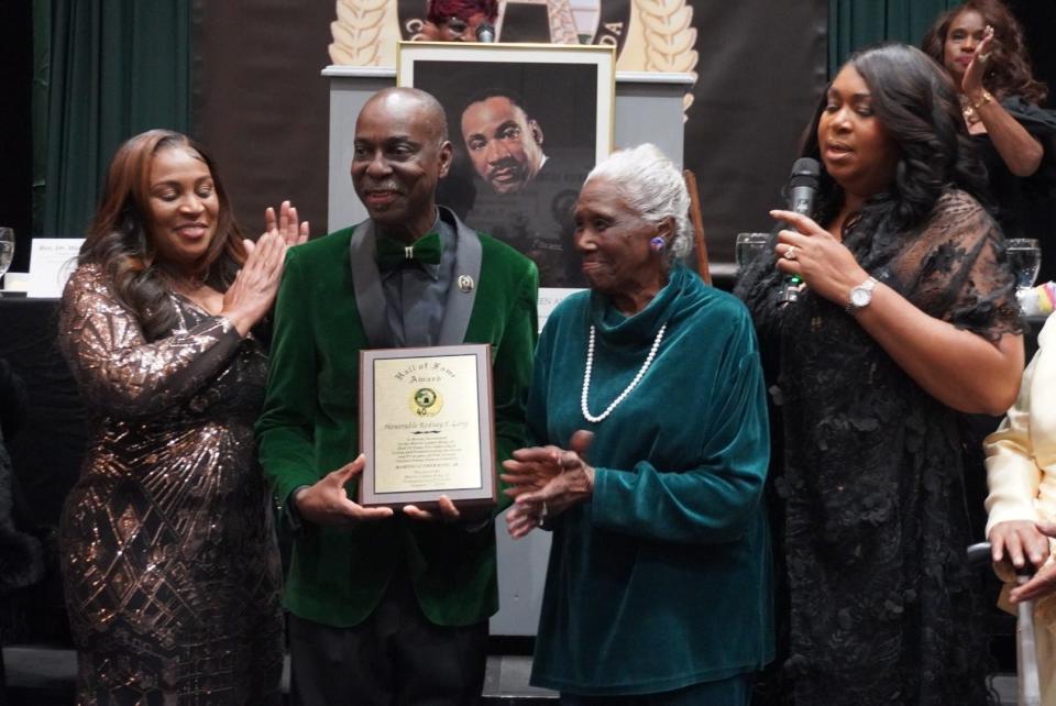 Rodney Long, second from left, is flanked from left by his wife, Carole Martin Long, his first grade teacher Ruth Brown and Diyonne McGraw as he accepts an award for being inducted into the MLK Commission of Florida Hall of Fame on Sunday.
(Credit: Photo by Voleer Thomas, Correspondent)