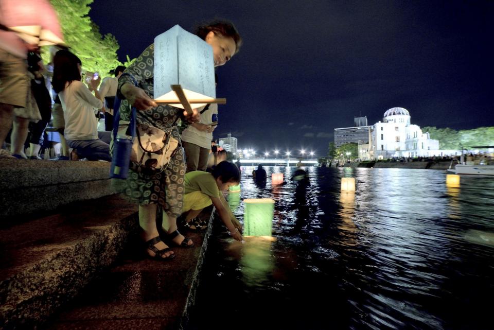 <p>People attend the Peace Message Lantern Floating Ceremony held to console the souls of the A-Bomb victims after the Hiroshima Peace Memorial Ceremony at the Hiroshima Peace Memorial Park on the occasion of the 72nd anniversary of Hiroshima atomic bombing on Aug. 6, 2017 in Hiroshima, Japan. (Photo: David Mareuil/Anadolu Agency/Getty Images) </p>