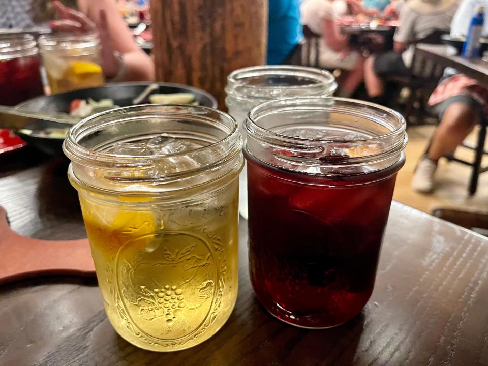 Hoop-De-Doo Revue at Disney - mason jars with drinks inside on a wood table