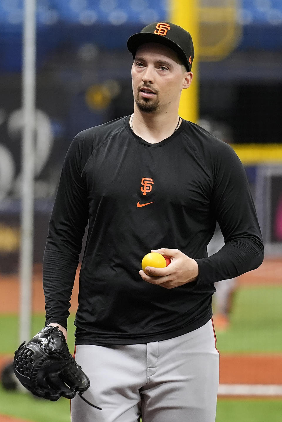 San Francisco Giants pitcher Blake Snell walks across the field before a baseball game against the Tampa Bay Rays, Friday, April 12, 2024, in St. Petersburg, Fla. Snell, a former pitcher for the Rays, is making his first trip to Tropicana Field since leaving the team. (AP Photo/Chris O'Meara)