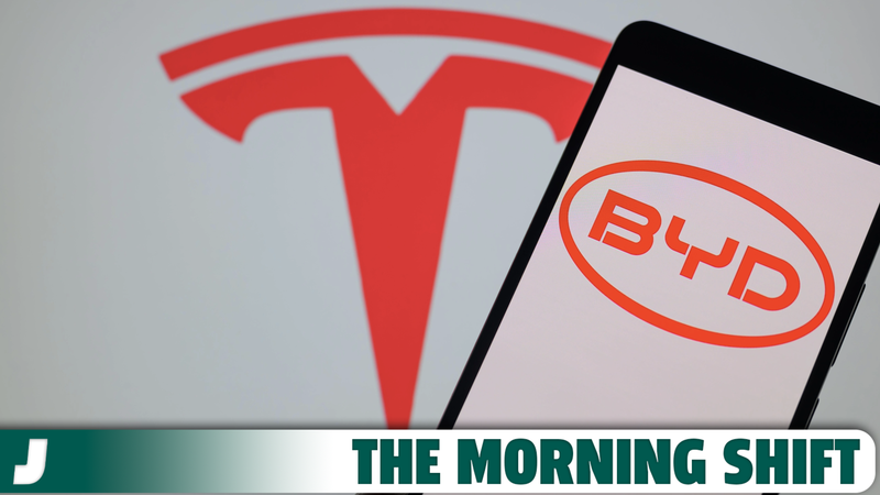 The BYD logo is being displayed on a smartphone with the Tesla logo visible in the background in this photo illustration in Brussels, Belgium, on January 21, 2024.