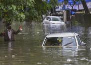 Mumbai: A man wades through a waterlogged street after heavy monsoon rain, at Sion in Mumbai, Wednesday, Sept. 23, 2020. (PTI Photo/Kunal Patil)(PTI23-09-2020_000074B)