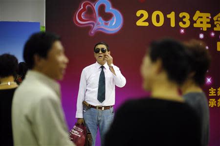 A man arrives at a matchmaking event for middle-aged singles and seniors, sponsored by Shanghai's government, in Shanghai November 9, 2013. REUTERS/Carlos Barria