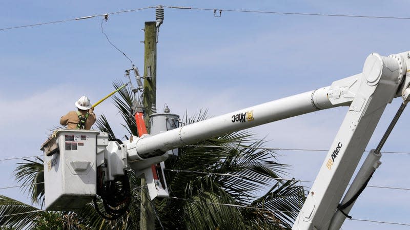 A Florida Power & Light technician repairs a line in Miami Gardens in 2016. 