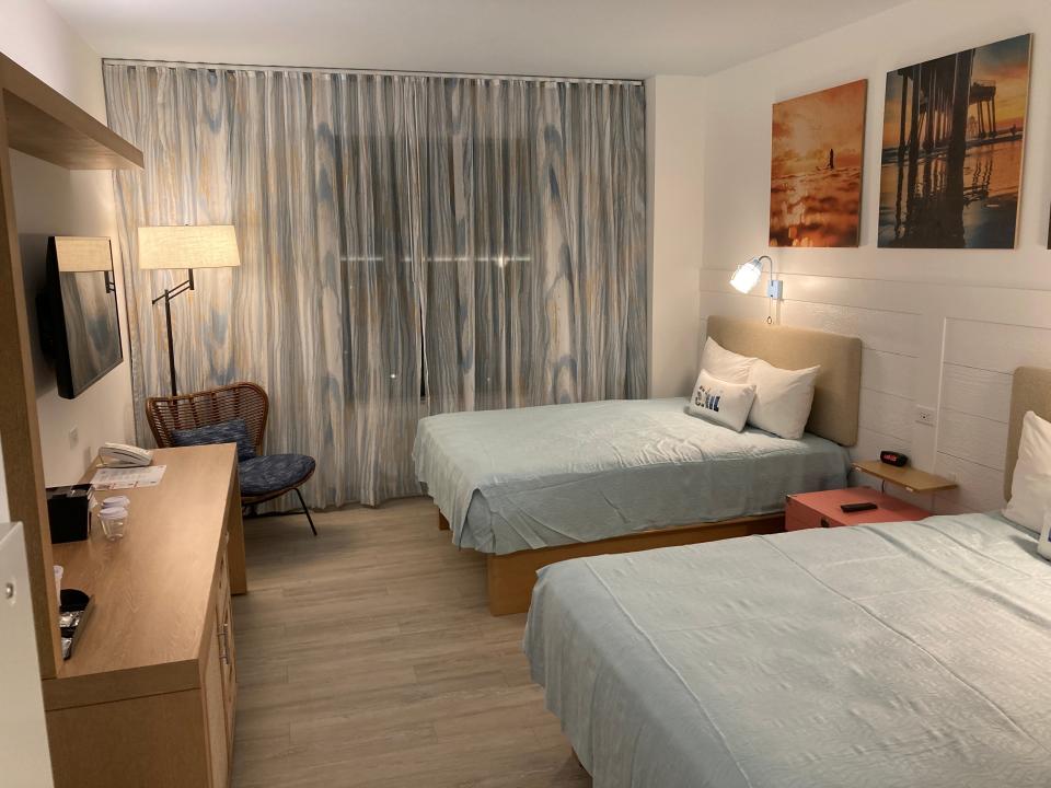 standard room with two double beds (blue comforters and pictures above the beds) at dockside resort