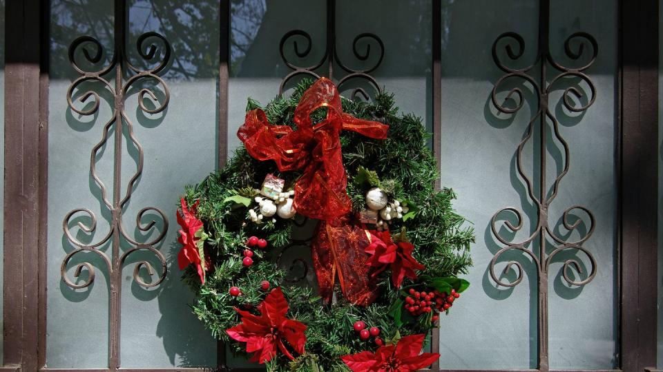 christmas wreath on an elegant wrought iron and frosted glass front door