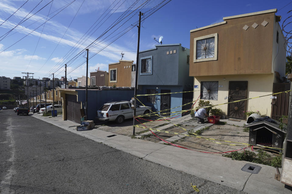 FILE - Police tape surrounds the crime scene and house of murdered journalist Lourdes Maldonado who was shot to death in her car as she arrived home, in Tijuana, Mexico, Jan. 25, 2022. The murder of Lourdes Maldonado occurred 5 days after murder of a photojournalist, marking it the third murder of a journalist in the country in two weeks. (AP Photo/Marco Ugarte, File)